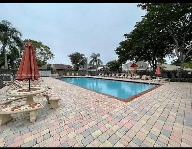 a view of a swimming pool and lounge chairs
