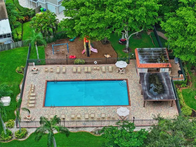 an aerial view of a house with a yard basket ball court and outdoor seating