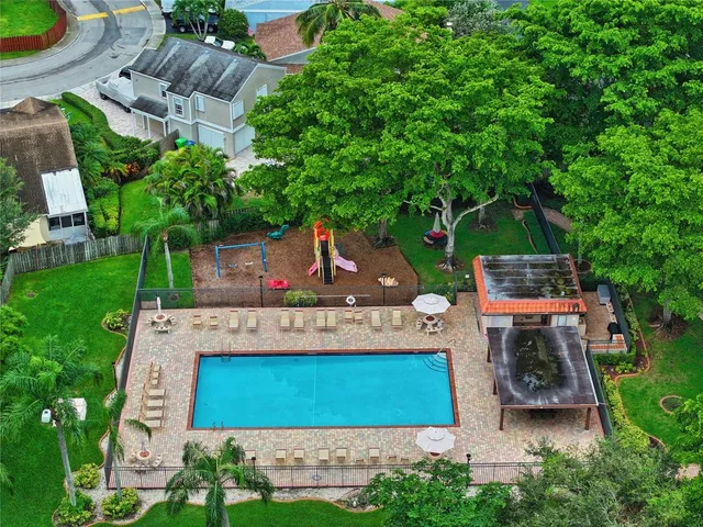 an aerial view of a house with garden space and street view