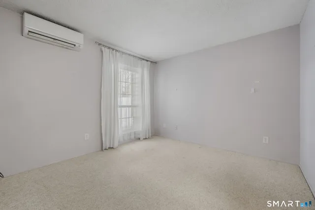 a view of an empty room and a window