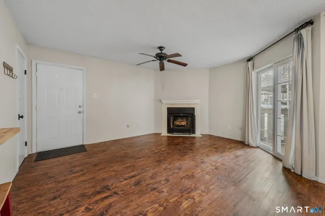 wooden floor in an empty room with a fireplace