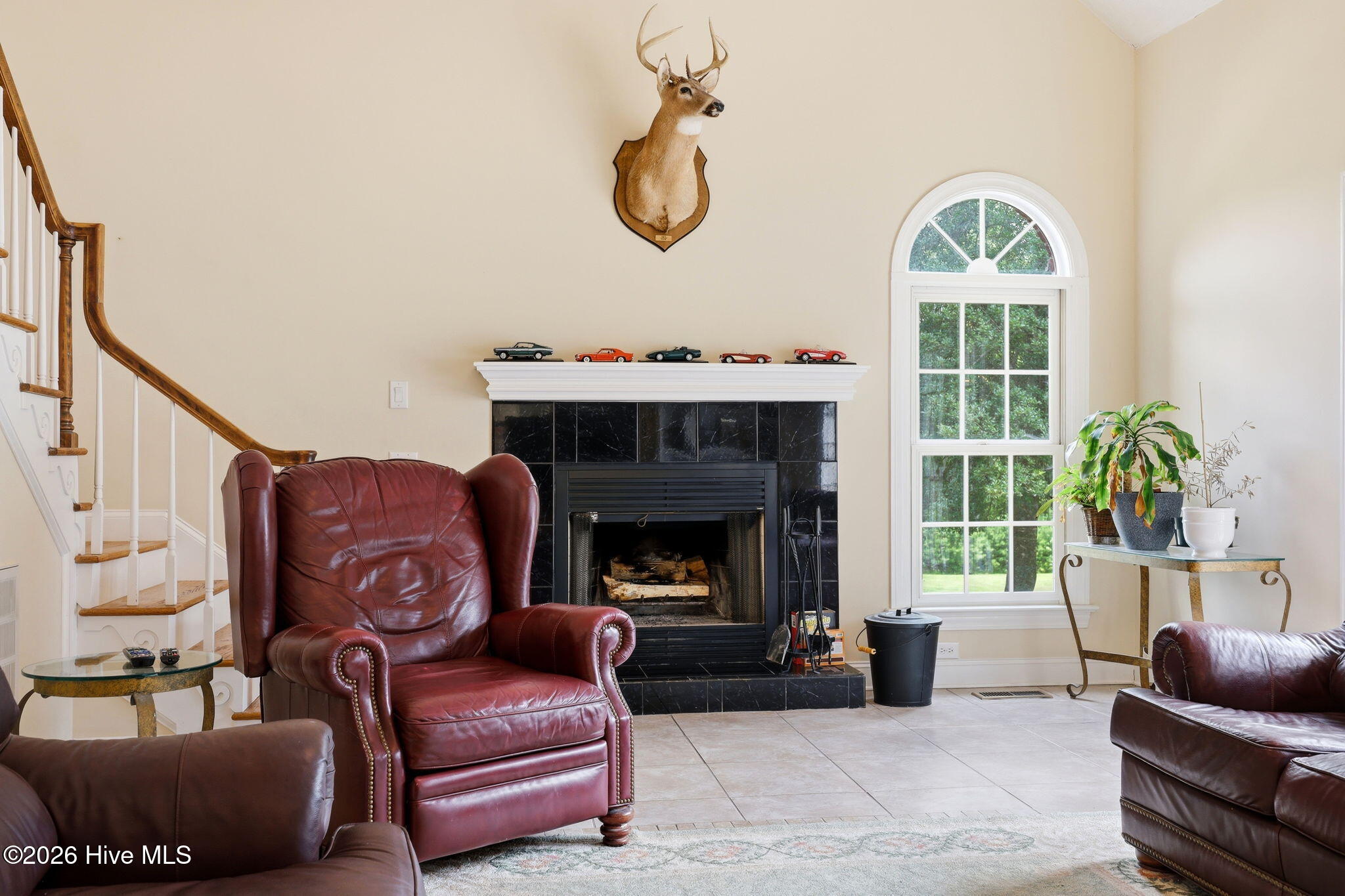 4076 Mobleys Bridge Road Grimesland, NC 27837 - Photo 16 of 66 fireplace and arched window - back staircase ( there is a front access at foyer as well