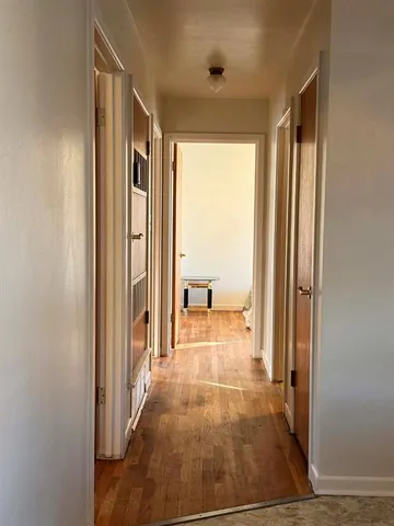 a view of a hallway with a large window and couch