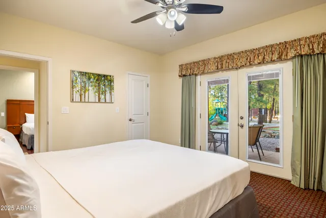 a bedroom with a large bed and a chandelier