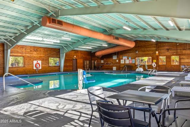 a patio with a table and chairs and a barbeque