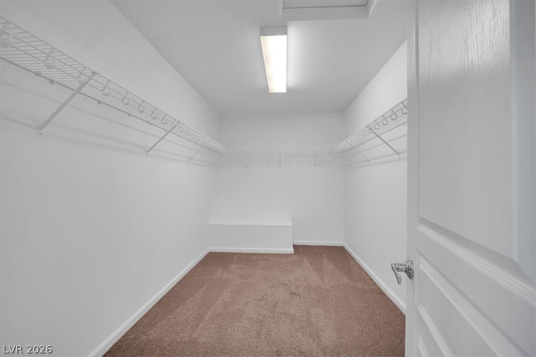 8046 Noble Ridge Street Las Vegas, NV 89139 - Photo 19 of 34 Ample shelving and hanging space defines this practical, naturally lit walk-in closet.