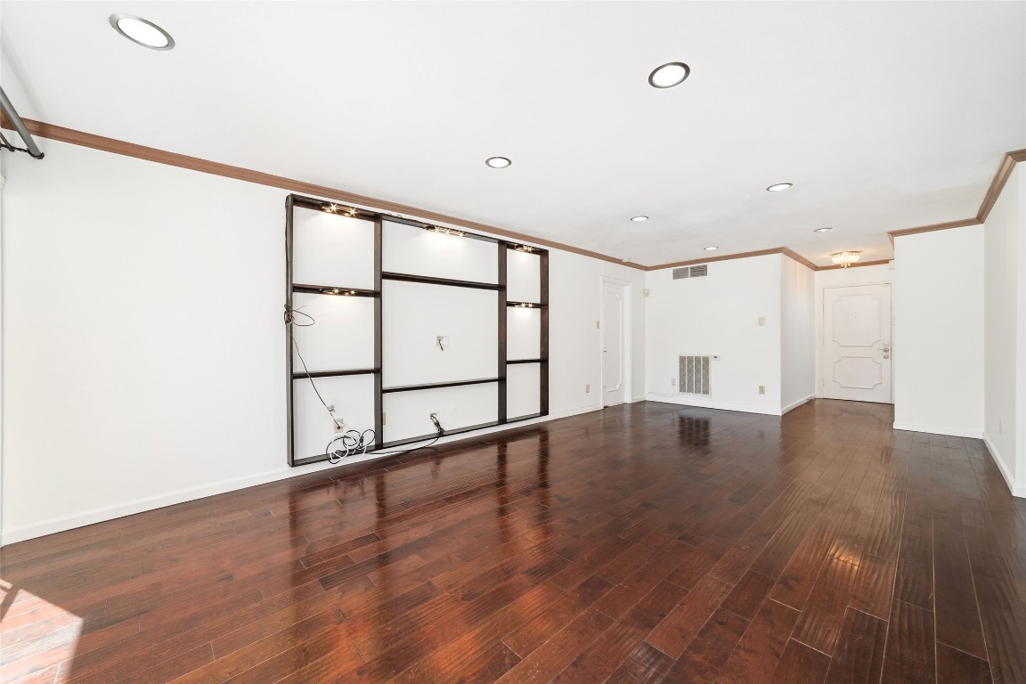 5050 Ambassador Way, Unit 309 Houston, TX 77056 - Photo 11 of 42 a view of an empty room with wooden floor