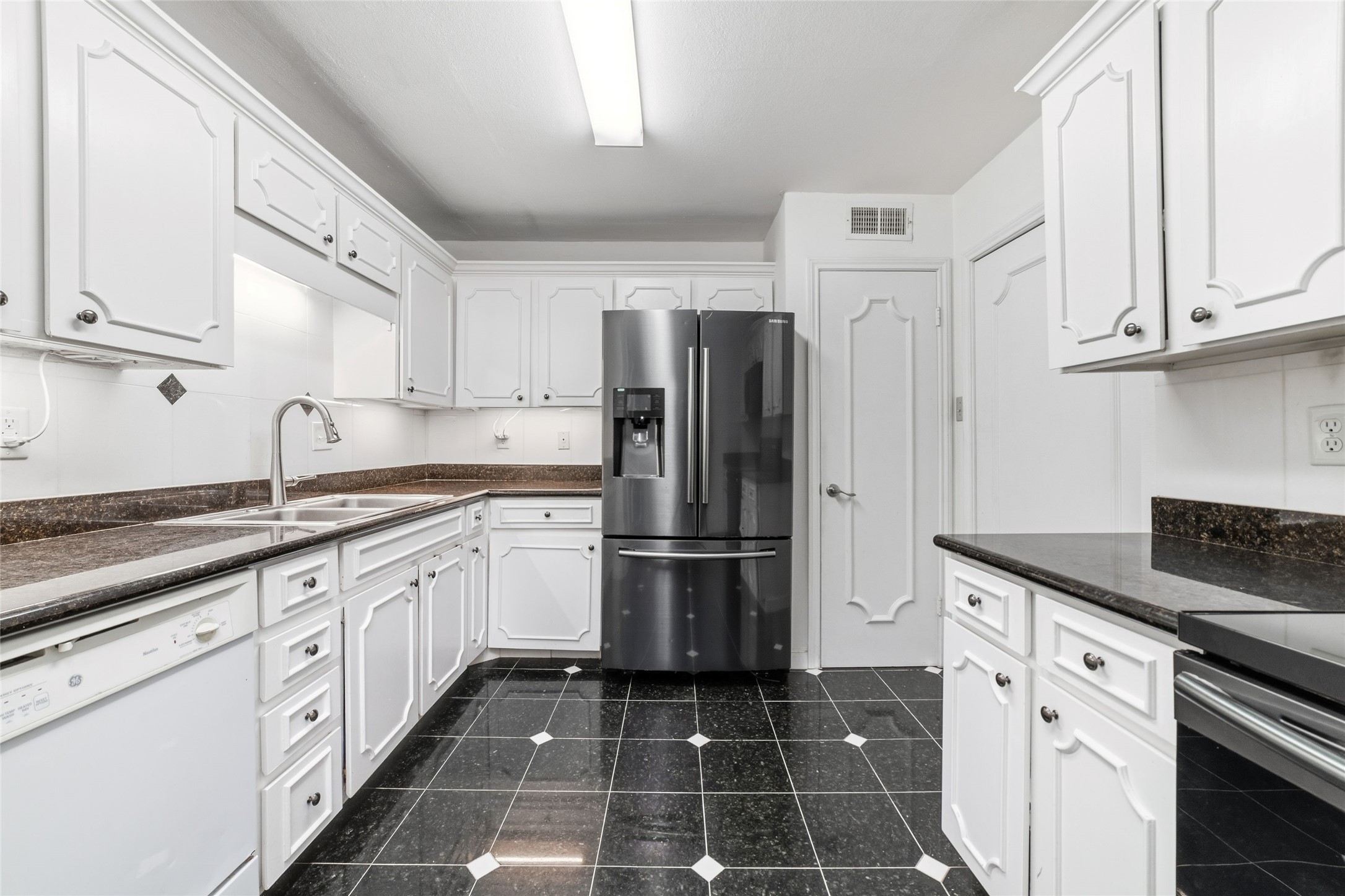 5050 Ambassador Way, Unit 309 Houston, TX 77056 - Photo 12 of 42 a kitchen with granite countertop appliances cabinets and a counter space