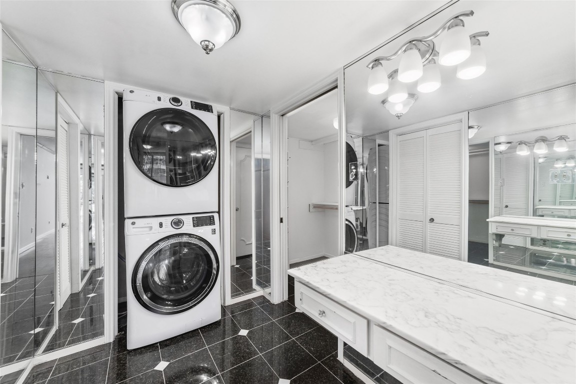 5050 Ambassador Way, Unit 309 Houston, TX 77056 - Photo 13 of 42 a bathroom with a sink and a washer dryer