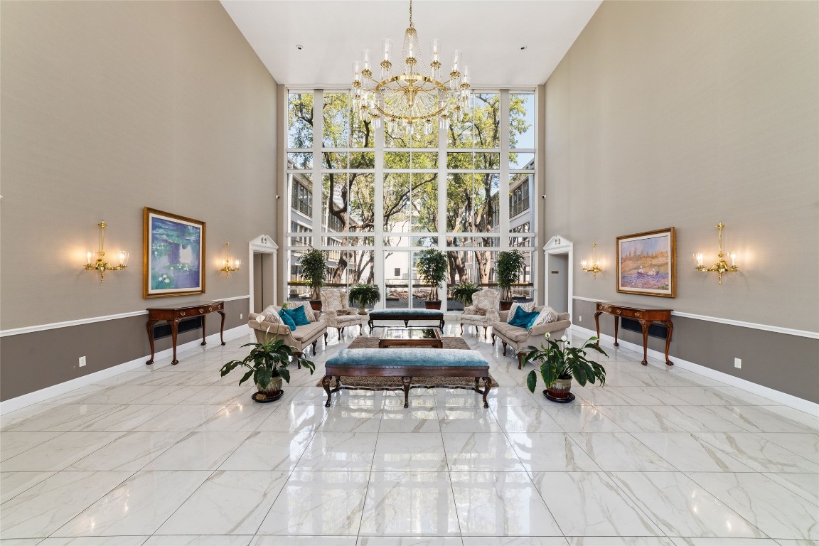 5050 Ambassador Way, Unit 309 Houston, TX 77056 - Photo 16 of 42 a living room with furniture and a chandelier