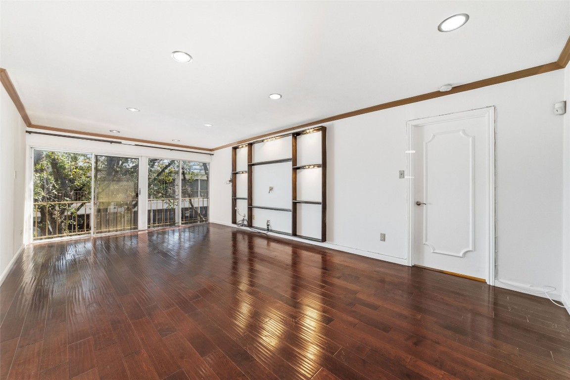 5050 Ambassador Way, Unit 309 Houston, TX 77056 - Photo 20 of 42 a view of an empty room with wooden floor and a window