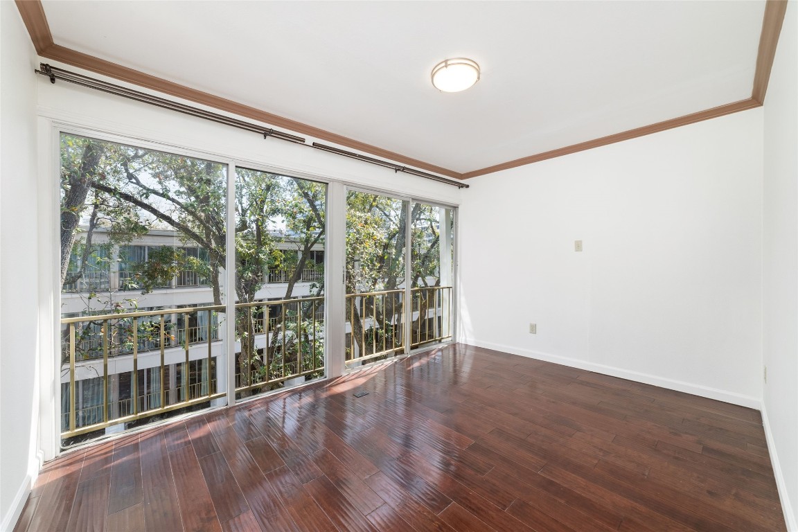 5050 Ambassador Way, Unit 309 Houston, TX 77056 - Photo 24 of 42 a view of a big room with wooden floor and windows
