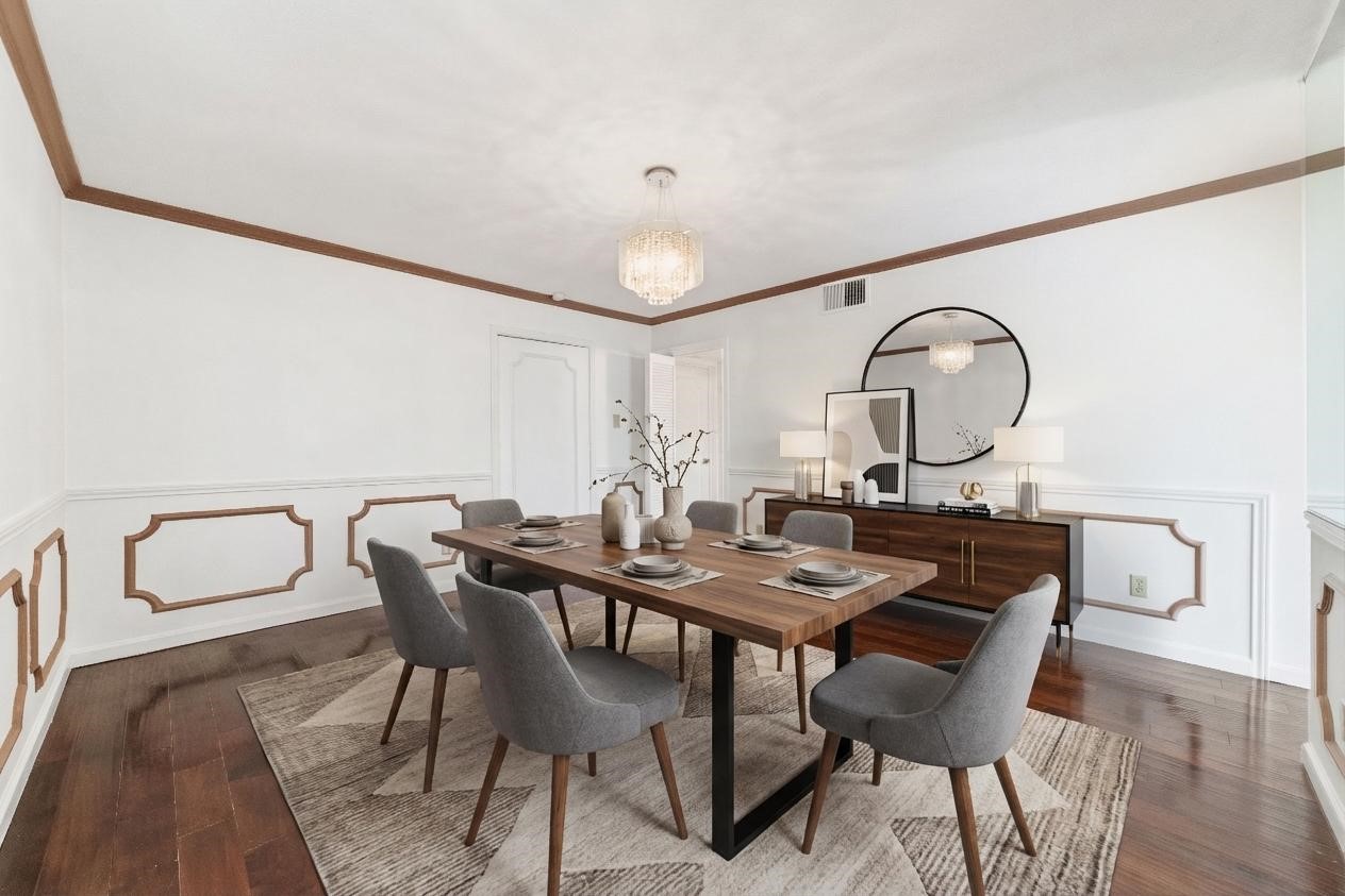 5050 Ambassador Way, Unit 309 Houston, TX 77056 - Photo 3 of 42 a view of a dining room with furniture and a chandelier