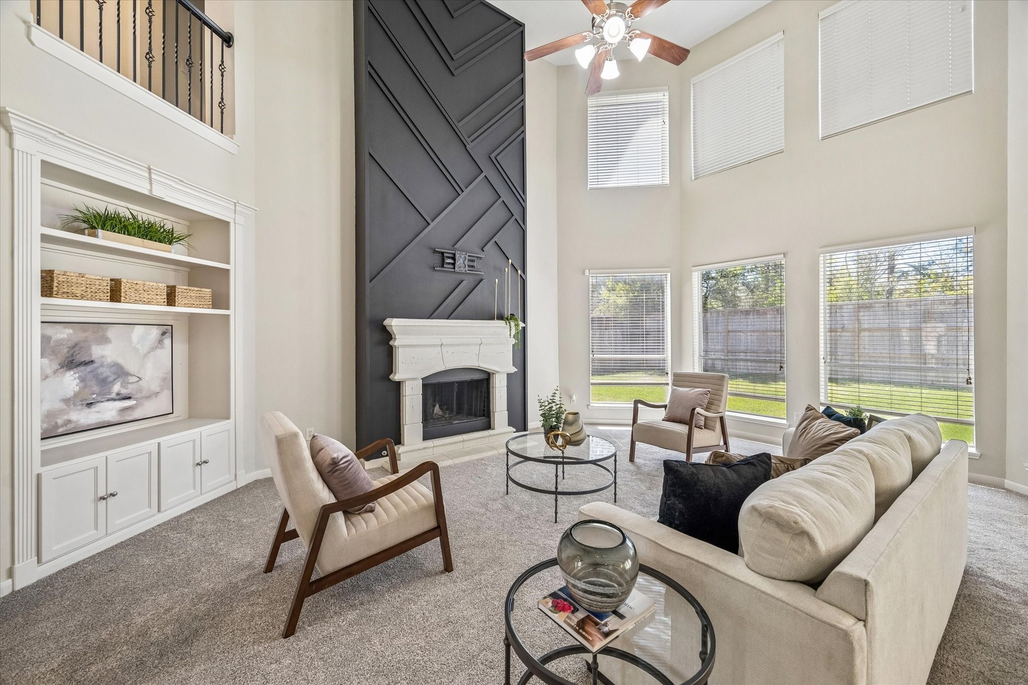 25827 Austin Springs Spring, TX 77373 - Photo 8 of 34 Breath taking living room! Double story bay windows drench the space in natural light while a beautifully done fireplace grounds the living room.
