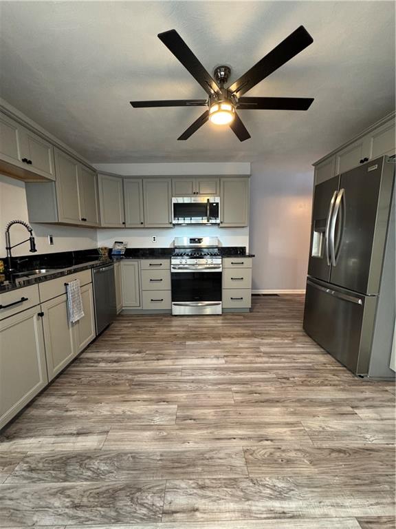 2422 Salisbury Street Pittsburgh, PA 15210 - Photo 3 of 13 a large kitchen with stainless steel appliances granite countertop a stove sink and refrigerator