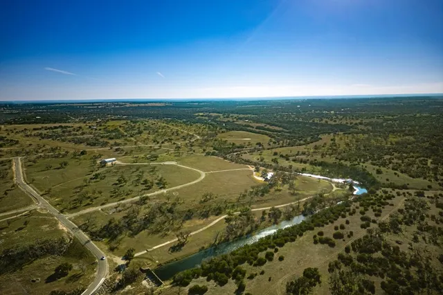 a view of a house with swimming pool and sitting area