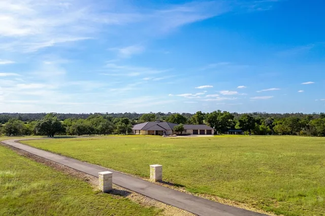 a living room with furniture and large windows
