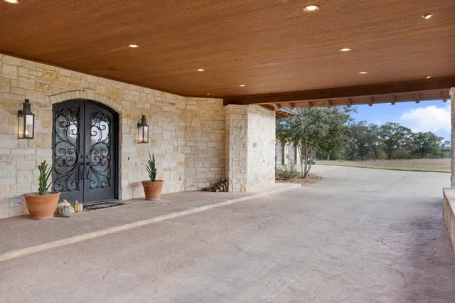 a dining room with furniture and large windows