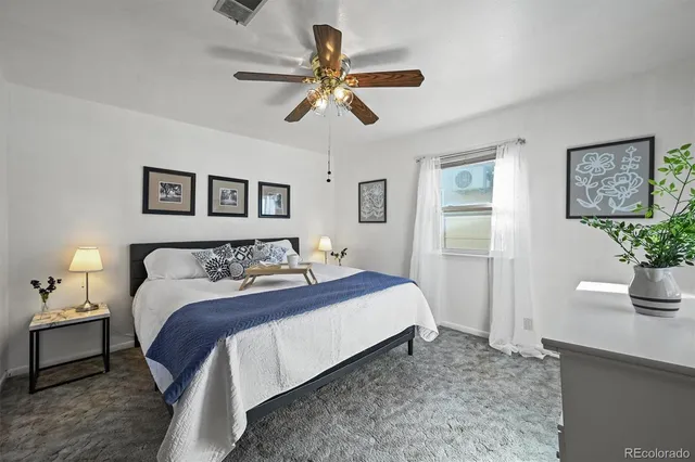 a bed room with a bed and a potted plant