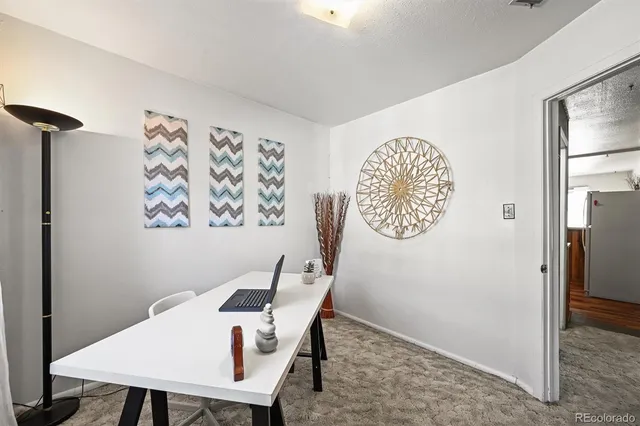 a view of a room that has a table and a chair