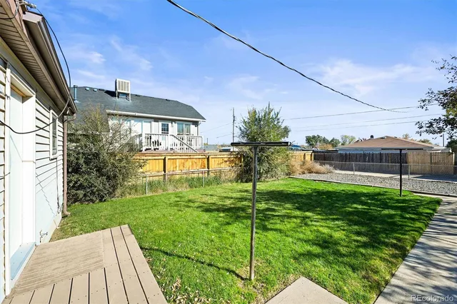 a view of backyard with seating area and green space