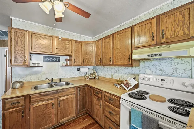 a kitchen with a sink stove top oven and cabinets