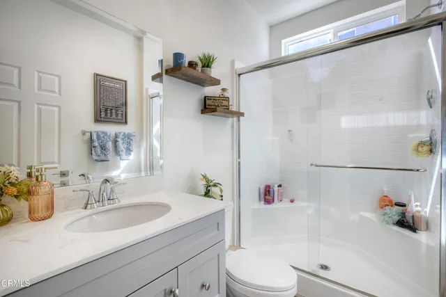 a bathroom with a sink a toilet and a shower curtain