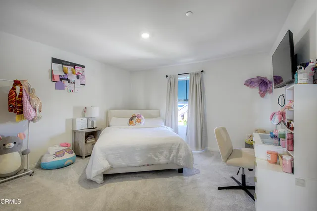 a bedroom with a bed and a desk