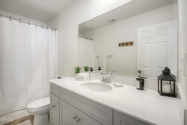 a bathroom with a sink double vanity and toilet