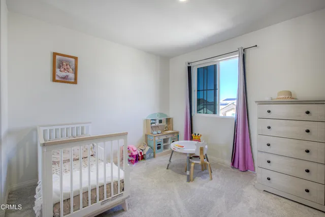 a bedroom with a bunk bed and a dresser