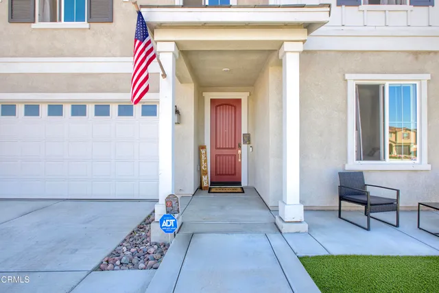 a view of front door of a house with a bench and chair