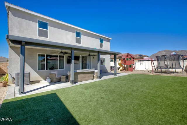 a view of a house with a yard porch and sitting area