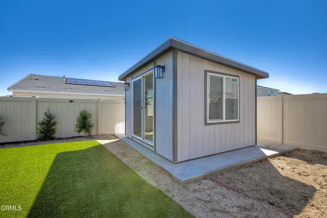 a view of a house with a yard and floor to ceiling window