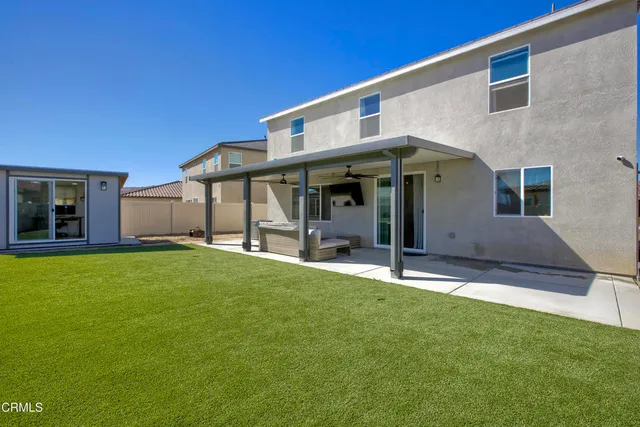 a view of an house with backyard porch and furniture