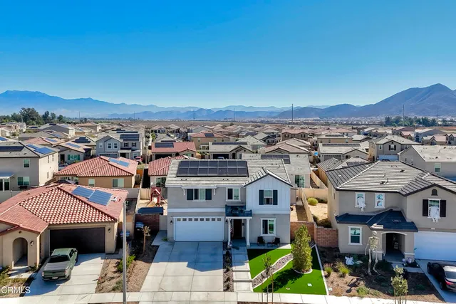 an aerial view of a house with swimming pool and ocean view