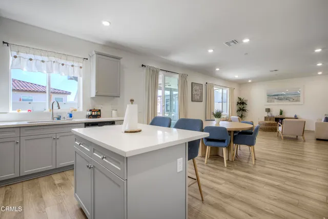 a large kitchen with a table and chairs