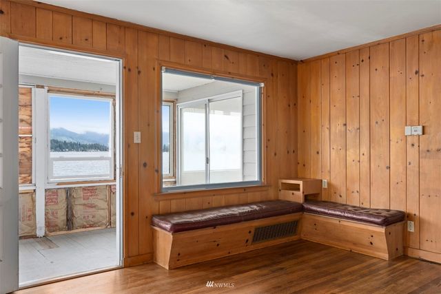 a view of a room with wooden floor and cabinet