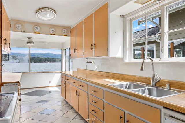 a kitchen with stainless steel appliances a sink and a cabinets