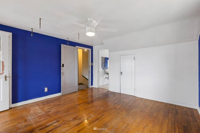 a view of a livingroom with wooden floor and window