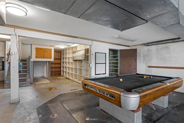 a living room with stainless steel appliances kitchen island a stove and a refrigerator