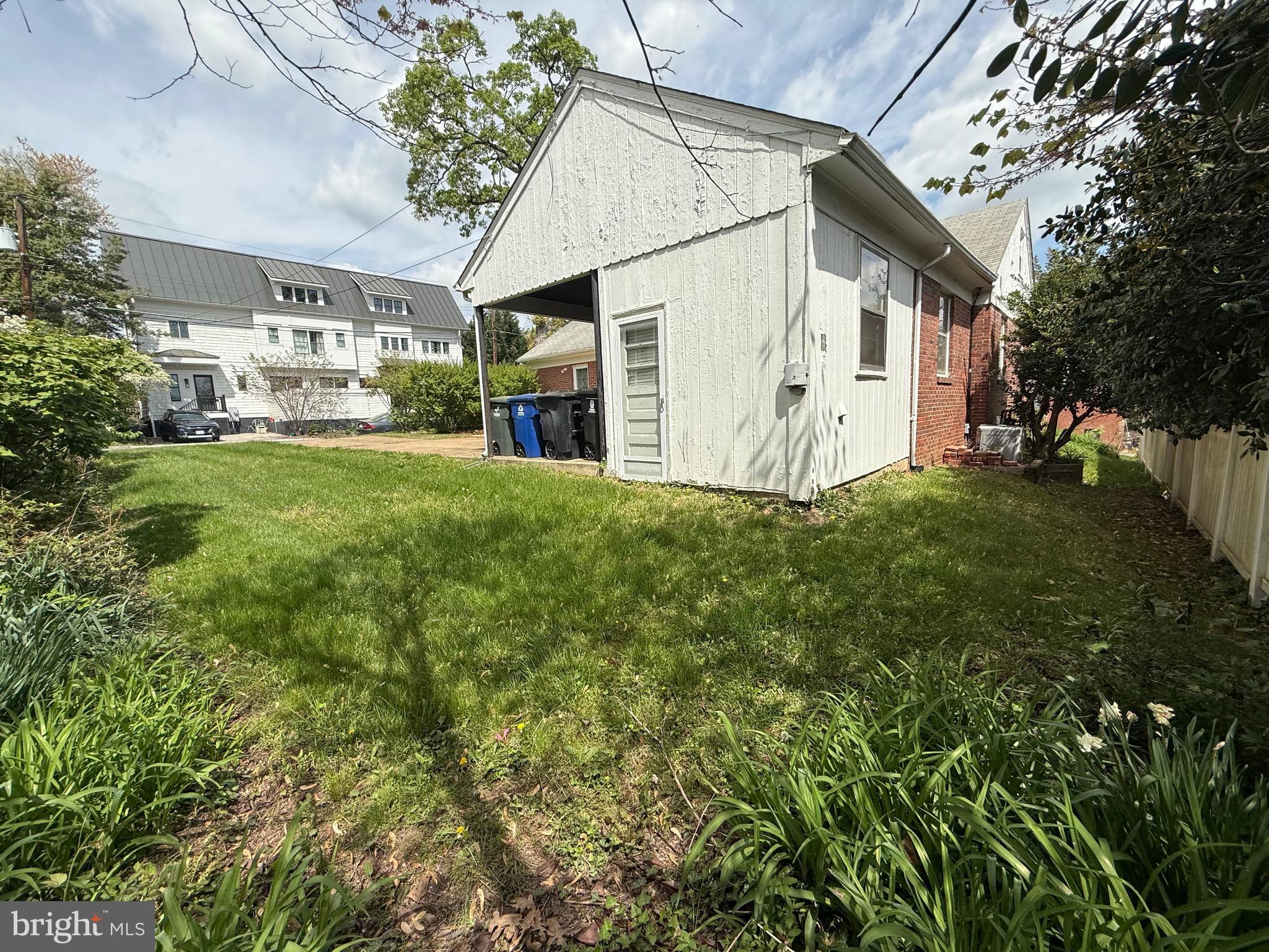 2846 Lorcom Lane Arlington, VA 22201 - Photo 4 of 8 a view of a white house with a big yard plants and large trees