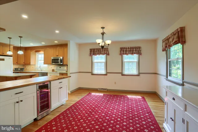 a kitchen with granite countertop stainless steel appliances a sink stove and cabinets