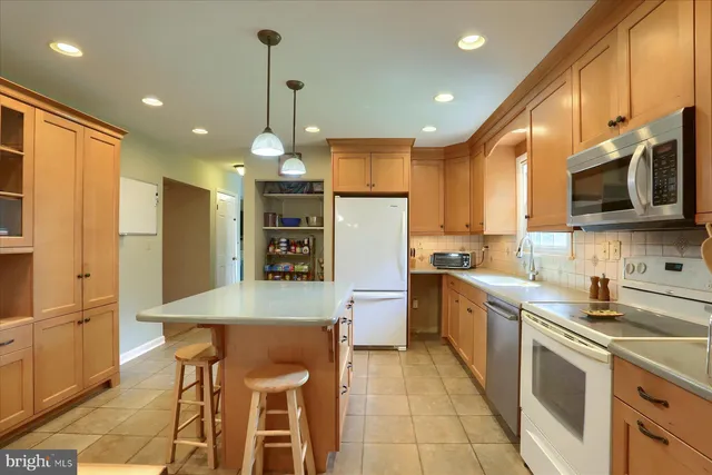 a kitchen with a sink a counter top space stainless steel appliances and cabinets