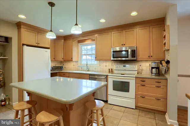 a kitchen with a stove a sink and a refrigerator