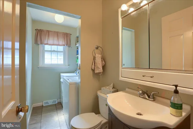 a bathroom with a sink toilet and mirror