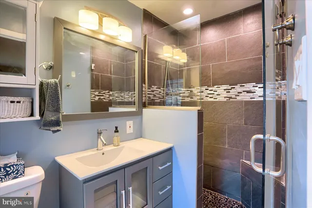 a bathroom with a sink toilet and shower