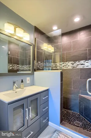 a bathroom with a sink a toilet and mirror