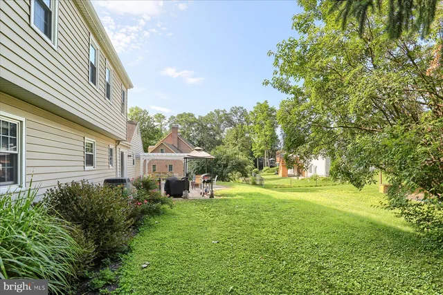 a front view of a house with a yard and trees
