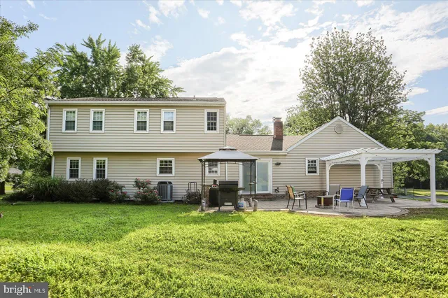 a front view of a house with a garden and plants
