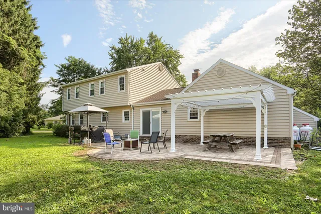 a front view of a house with a garden and patio